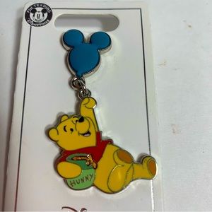 NWT. Disney Winnie the Pooh. Hanging from a Mickey shaped ballon & “hunny” jug